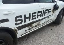A Hancock County Sheriff's Office cruiser driven by Deputy Butch Garst shows damage to the passenger side and a dangling mirror after a May 26 pursuit that began in Hancock County and continued into Ohio County. The sheriff's office said the driver, Cody Wedding, struck the cruiser while fleeing with his ex-wife and child in the vehicle before being taken into custody in Ohio County. 